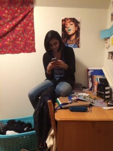 my wonderful roommate Sohini, sitting on her desk after rearranging our triple to reflect that only two of us were now living there.